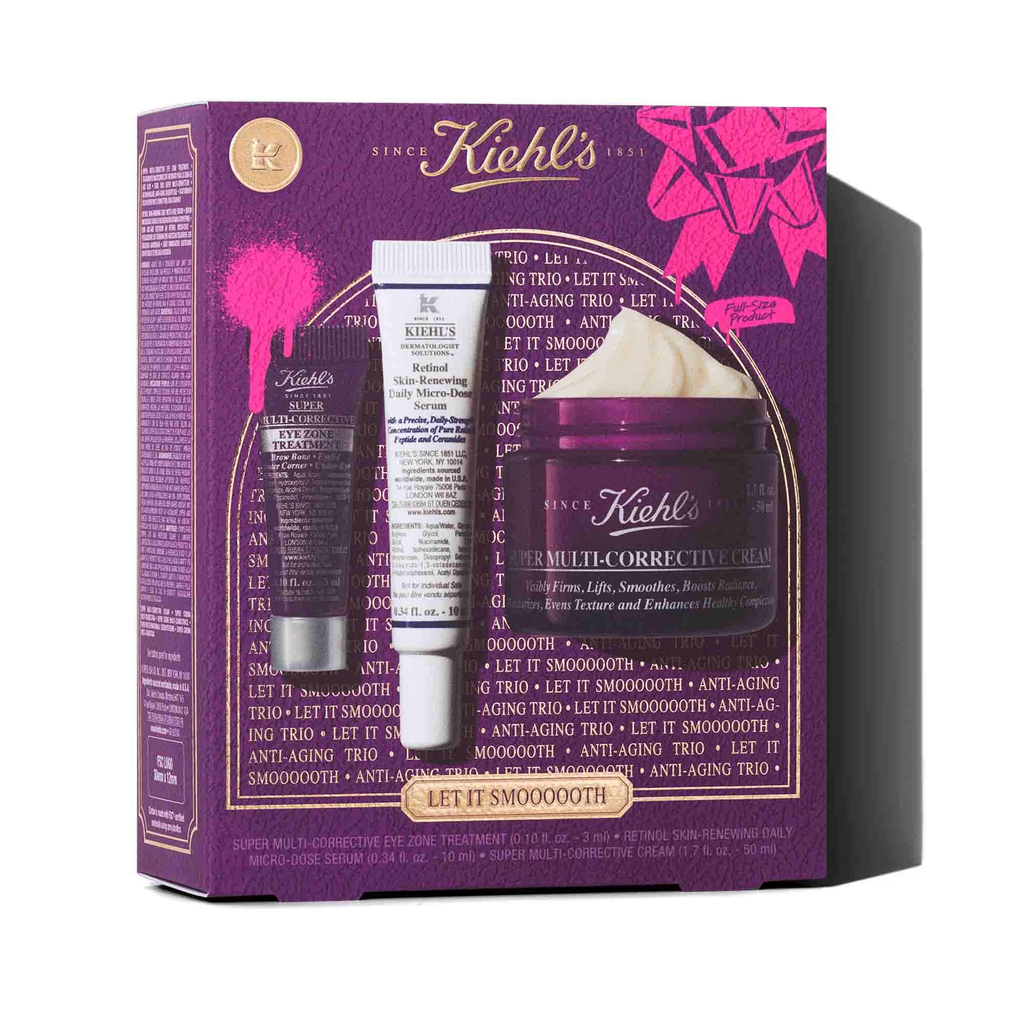 Grafika s fialovou darkovou krabičkou Kiehl's se zlatymi akcenty. Krabička obsahuje tři produkty: malou fialovou tubu "Kiehl's Super Multi-Corrective Eye Zone Treatment", bilou a fialovou tubu "Kiehl's Retinol Skin-Renewing Daily Micro-Dose Serum" a fialovou nadobu "Kiehl's Super Multi-Corrective Cream" s viditelnym kremem. Krabička je zdobena jasně růžovymi grafickymi střikanci barvy a vzorem mašle a ve spodni časti ma text "LET IT SMOOOOOTH".