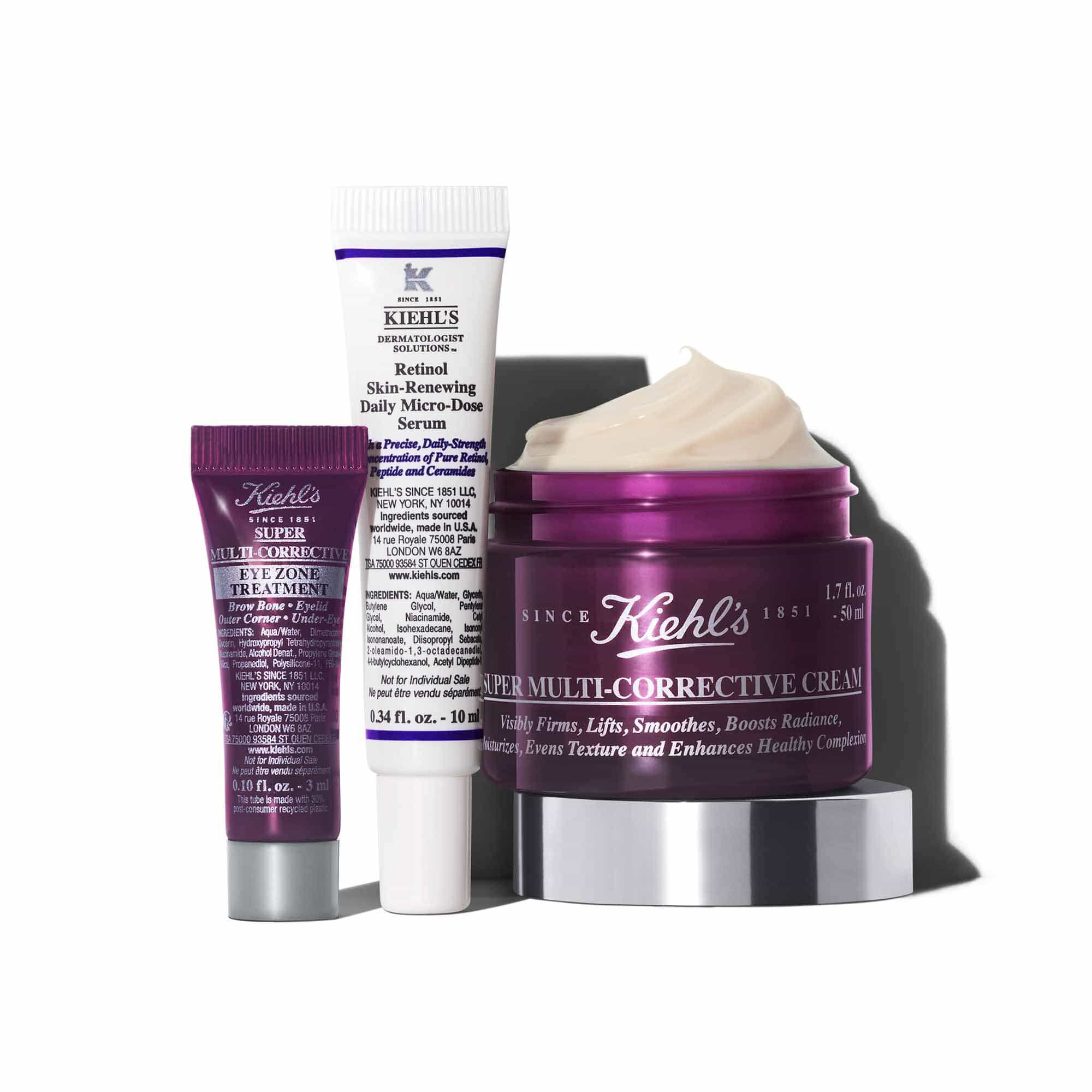 Grafika zobrazujici tři produkty Kiehl's vrhajici stin na bile pozadi: mala fialova tuba "Kiehl's Super Multi-Corrective Eye Zone Treatment", bila a fialova tuba "Kiehl's Retinol Skin-Renewing Daily Micro-Dose Serum" a otevřena fialova nadoba "Kiehl's Super Multi-Corrective Cream" s viditelnym kremem.