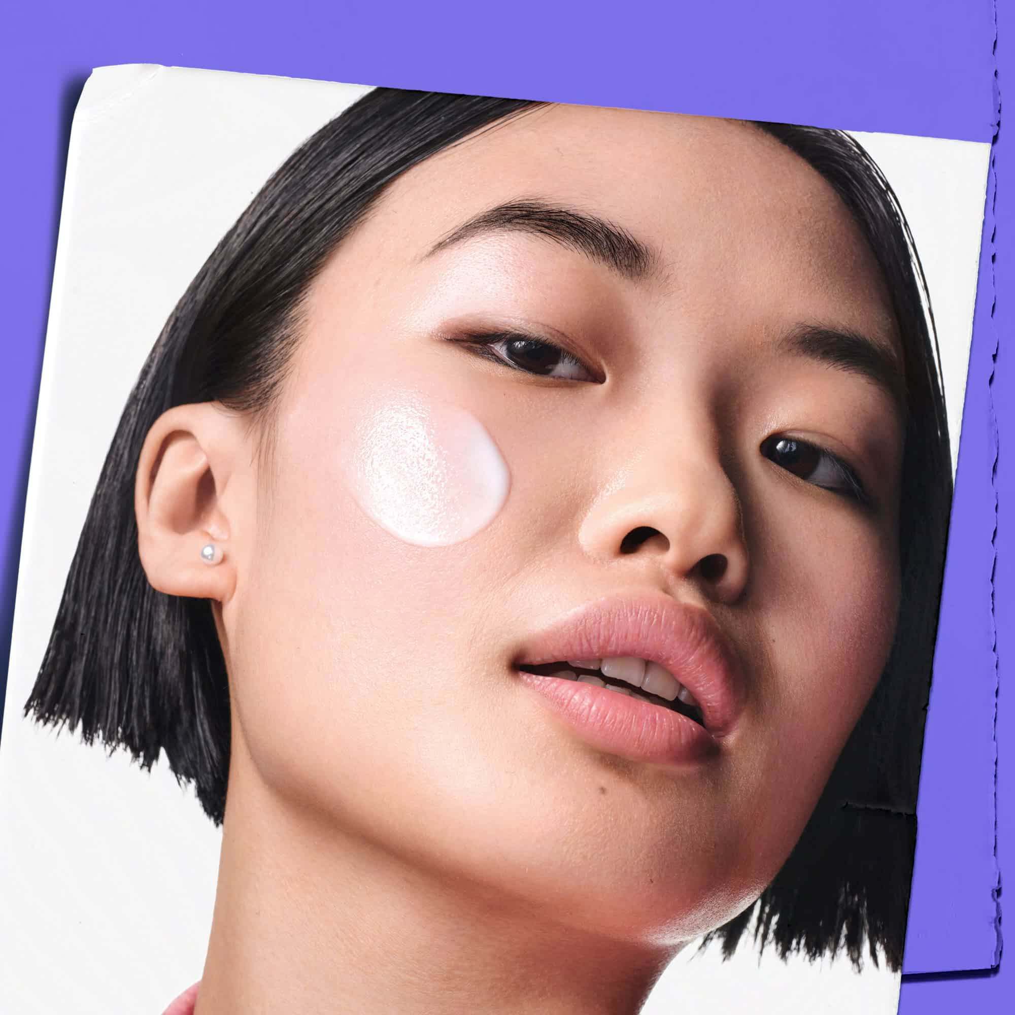 Model with Clearly Corrective™ Clarity-Boosting Soothing Emulsion sample on their cheek