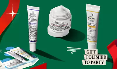 Hydrating Holiday Hits" skincare gift set on a green background, featuring Ultra Facial Cream and Creamy Eye Treatment with Avocado in festive packaging.