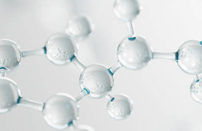 Close-up view of transparent molecular structures with spherical shapes and interconnected bonds, set against a soft, light background.